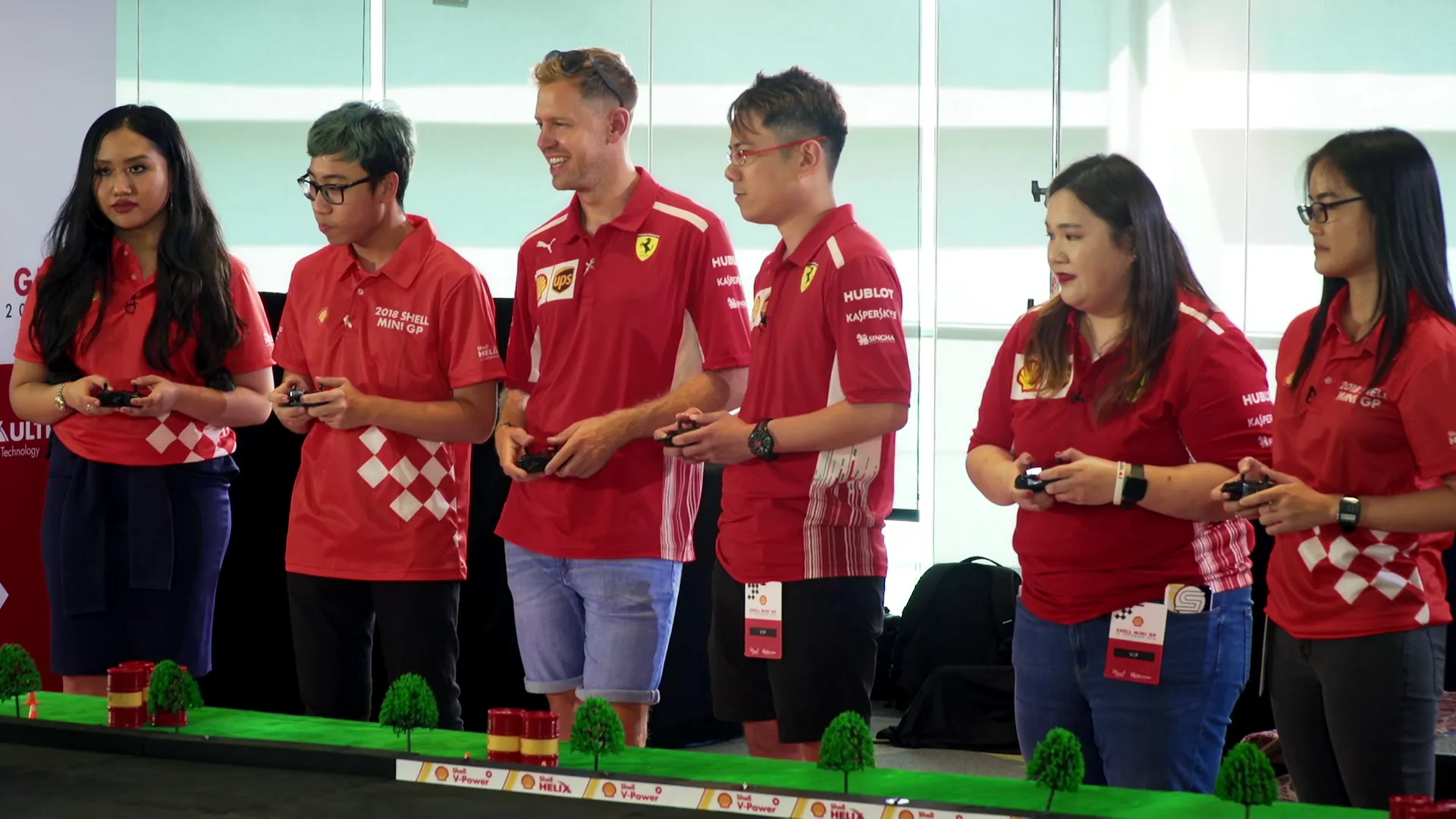 Shell Mini GP recap film still — racing wheel-to-wheel with fans